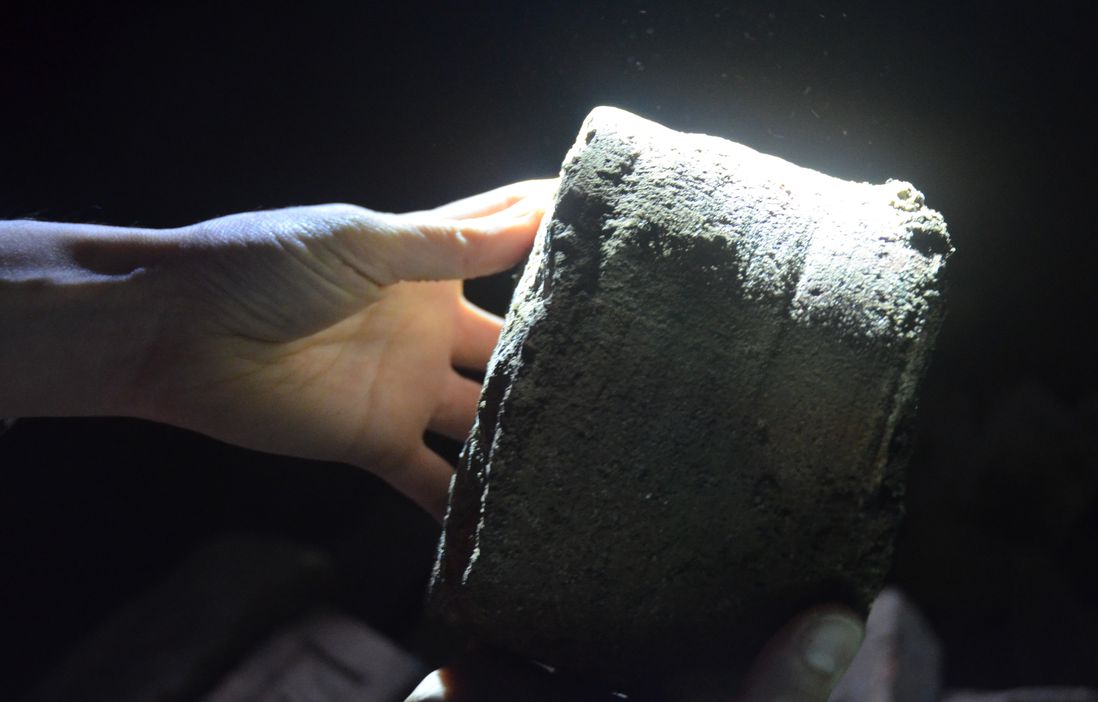 Macnow holds up a brick core found inside the bridge<br/>